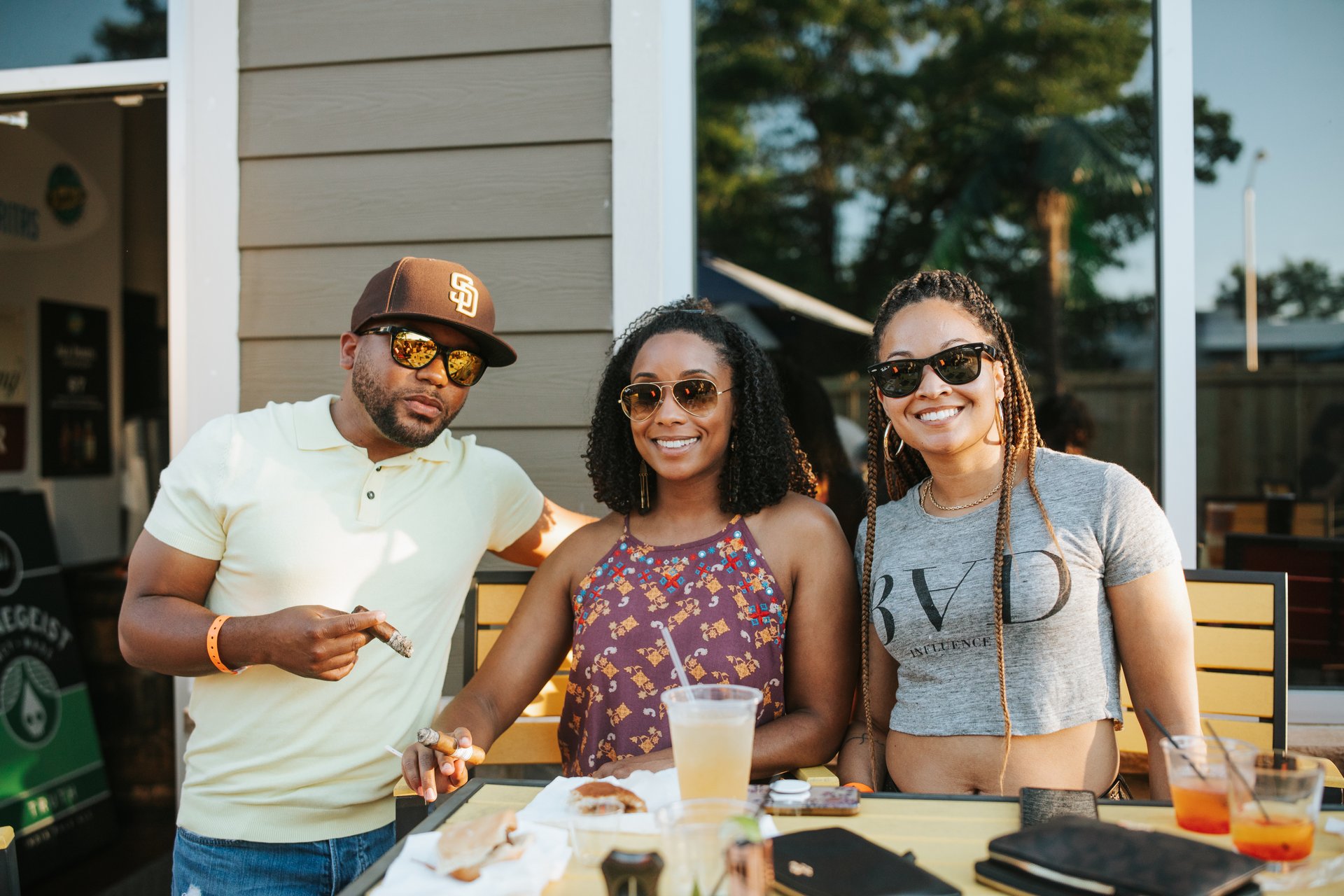 People drinking and enjoying cigars.