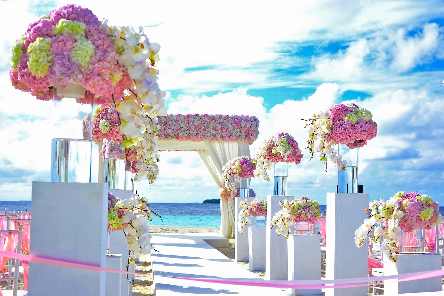 Gay Marriage Wedding in Mexico. Flowers and wedding ceremony with the beach and ocean in background. 